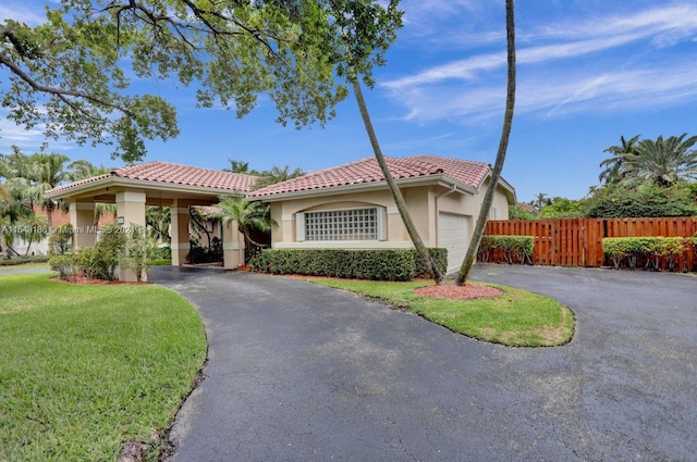 mediterranean / spanish home with a garage and a front lawn