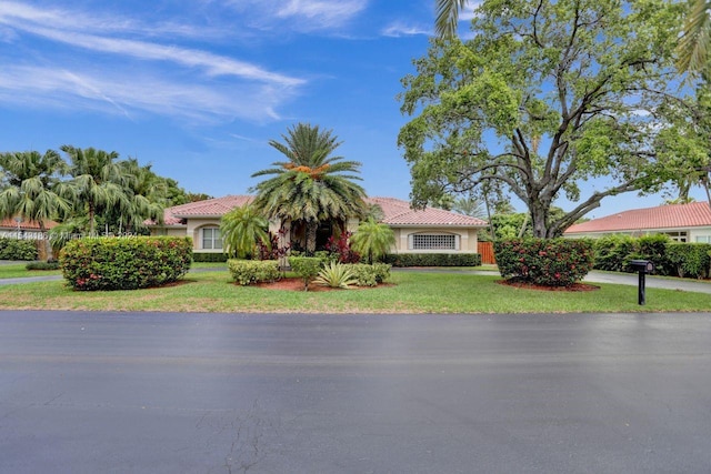 mediterranean / spanish-style house featuring a front lawn