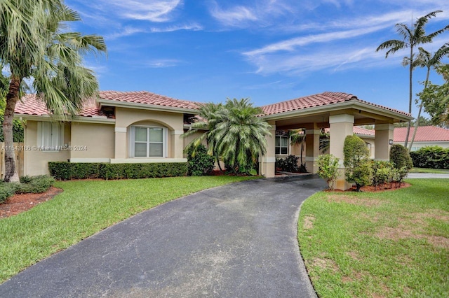 mediterranean / spanish-style house featuring a front yard