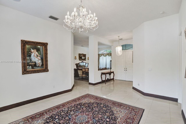 corridor with an inviting chandelier and light tile patterned floors