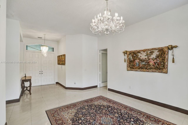 tiled foyer entrance featuring an inviting chandelier and vaulted ceiling