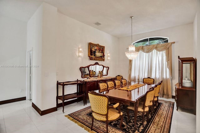 tiled dining room featuring a notable chandelier