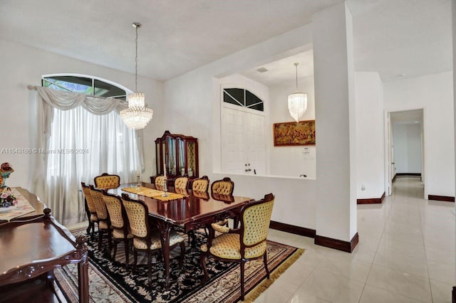 tiled dining space with an inviting chandelier