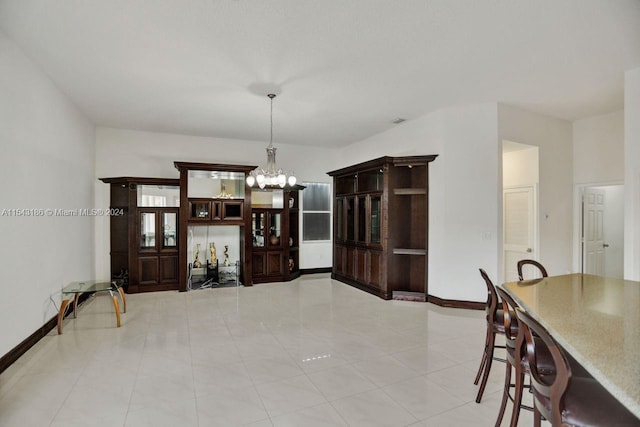 tiled dining room featuring a chandelier