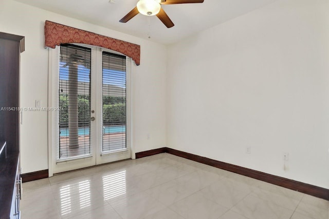 spare room with ceiling fan, light tile patterned floors, and french doors