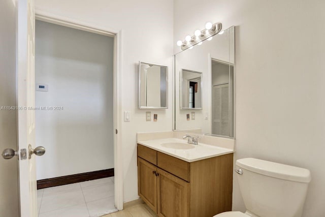 bathroom featuring toilet, vanity, and tile patterned flooring