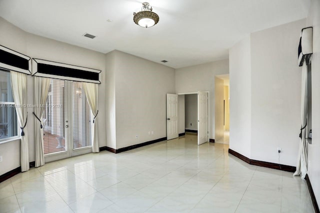 spare room featuring french doors