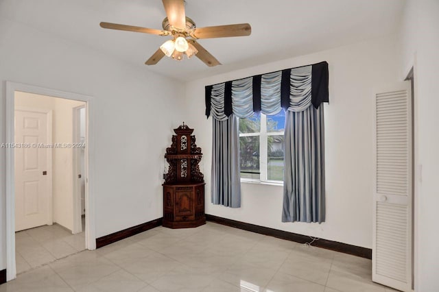 unfurnished bedroom featuring light tile patterned floors and ceiling fan