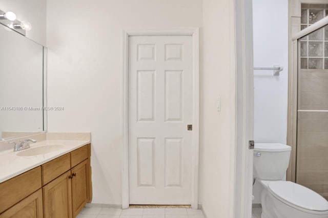 bathroom featuring toilet, tile patterned flooring, and vanity