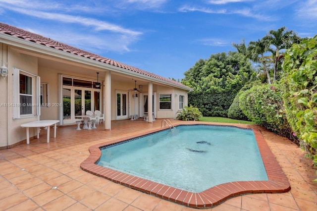 view of swimming pool with ceiling fan and a patio area