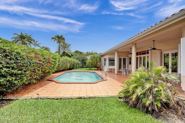 view of swimming pool with a patio, ceiling fan, and french doors