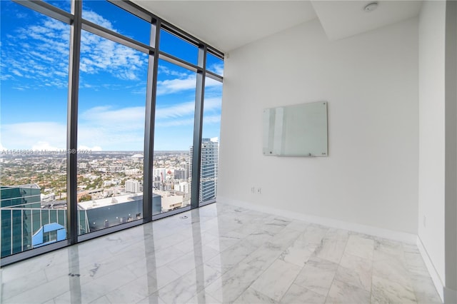 tiled empty room with plenty of natural light and a wall of windows