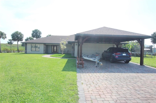 view of parking / parking lot with a garage and a yard