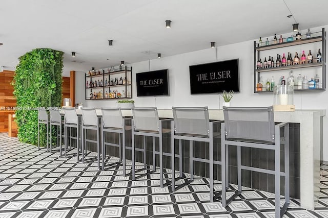 bar featuring dark tile floors