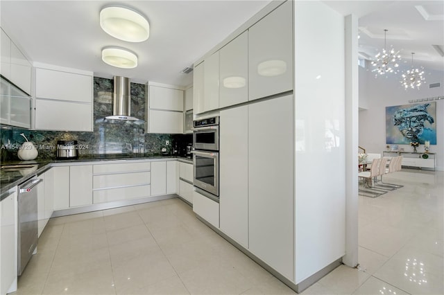 kitchen with white cabinets, light tile flooring, and wall chimney exhaust hood