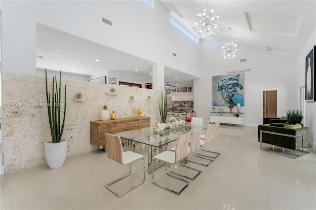 tiled dining space with a high ceiling, tile walls, and an inviting chandelier