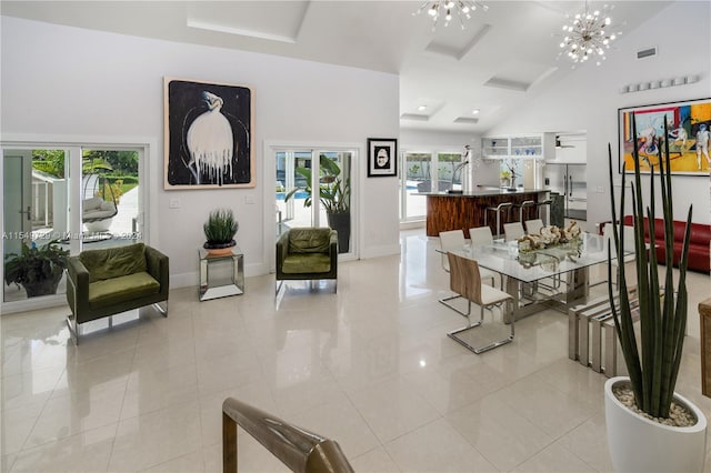 interior space featuring high vaulted ceiling, a notable chandelier, and light tile flooring