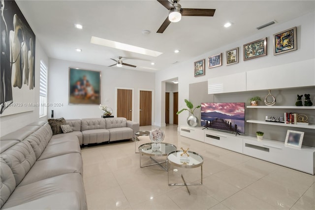 tiled living room with a skylight and ceiling fan