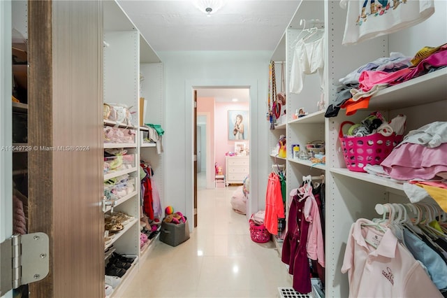 spacious closet featuring tile flooring