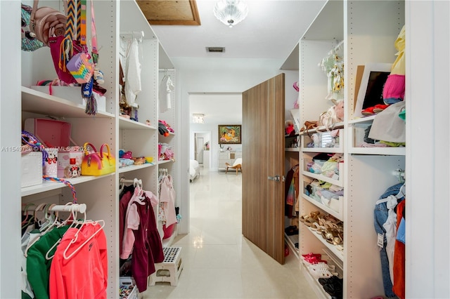 spacious closet featuring tile floors