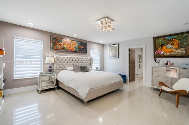 bedroom with light tile floors and an inviting chandelier