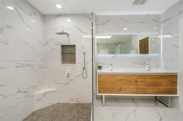 bathroom with tiled shower, tile floors, and vanity