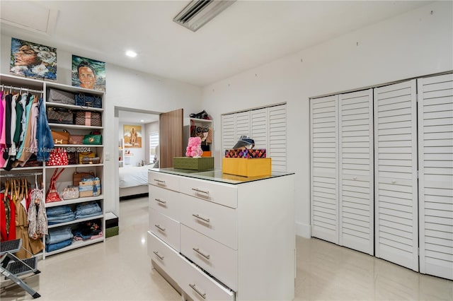 walk in closet featuring light tile floors