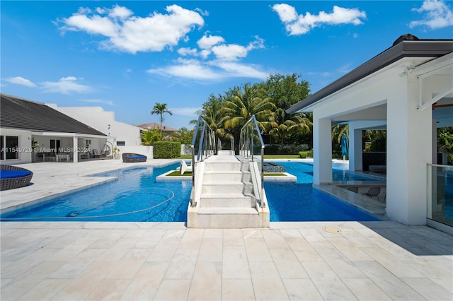 view of pool featuring a patio