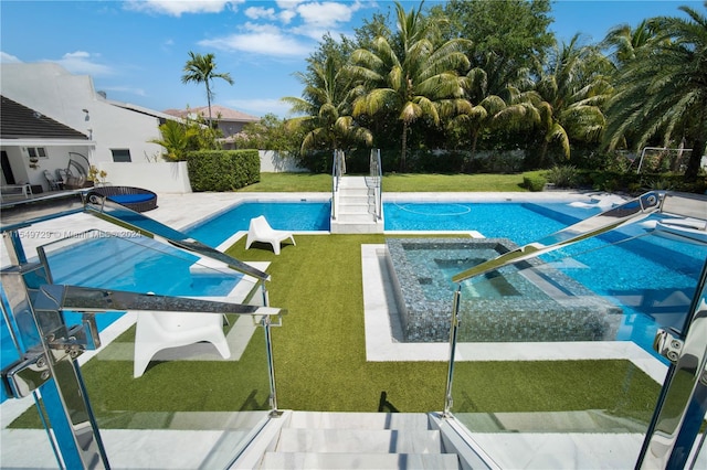 view of pool featuring a patio, a yard, and an in ground hot tub