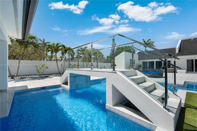 view of swimming pool with a patio and glass enclosure