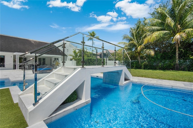 view of pool featuring a patio area, a yard, and a lanai