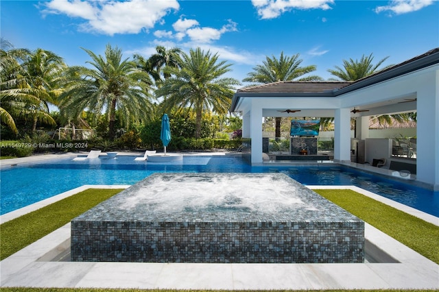 view of swimming pool featuring ceiling fan and a patio area