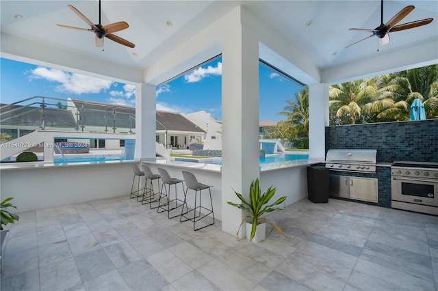 view of patio featuring ceiling fan, a grill, and an outdoor bar