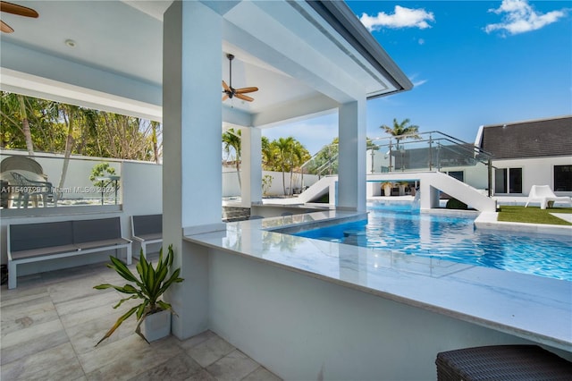 view of pool featuring ceiling fan and a patio area