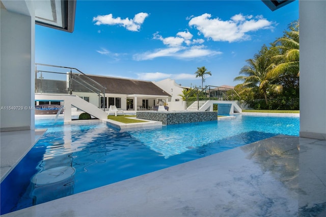 view of swimming pool with a patio