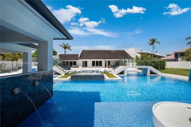 view of swimming pool with a patio area, pool water feature, and a hot tub