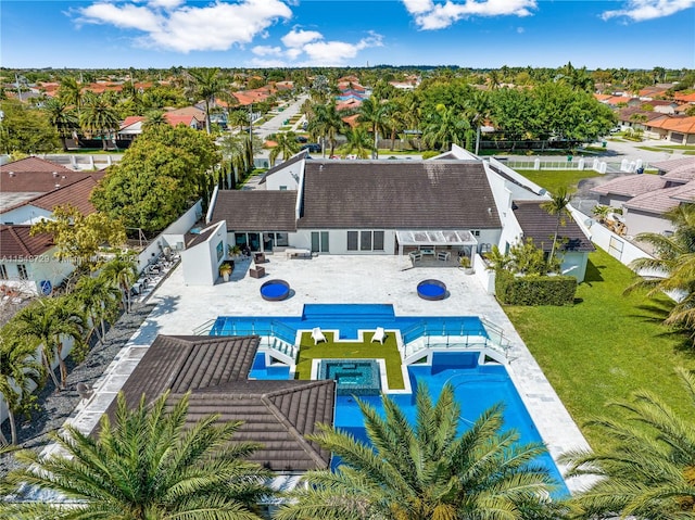 view of pool featuring a patio area, an in ground hot tub, and a lawn