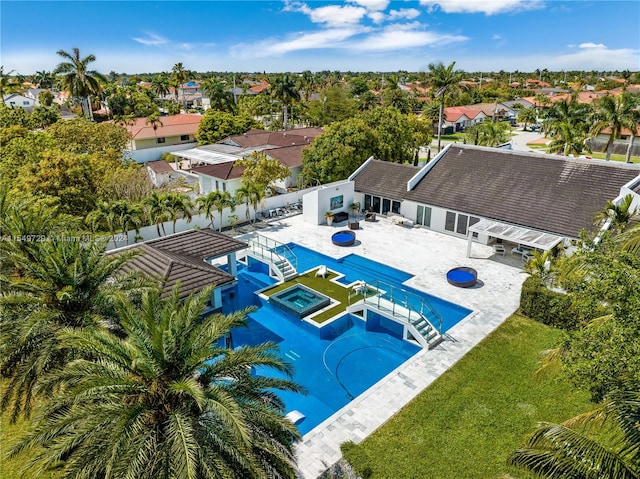 view of swimming pool featuring a yard, an in ground hot tub, and a patio area