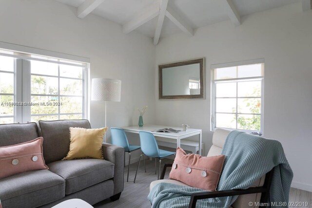 living room featuring light hardwood / wood-style floors and lofted ceiling with beams