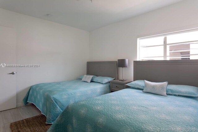 bedroom with hardwood / wood-style floors