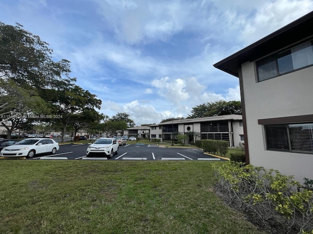 view of parking featuring a yard