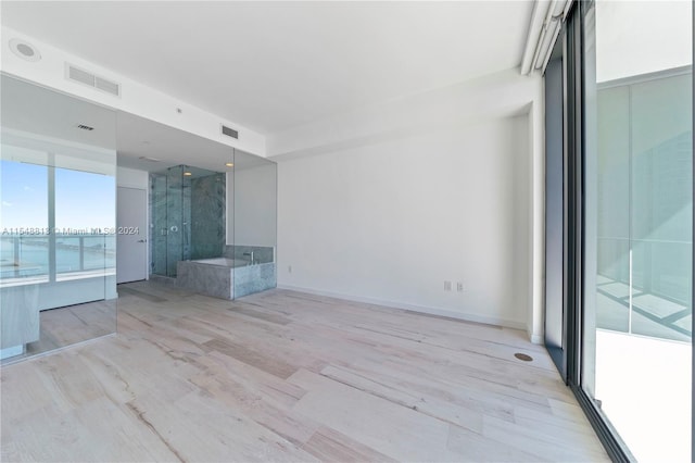 empty room with light hardwood / wood-style flooring