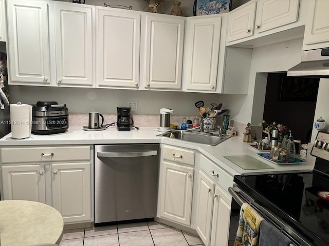 kitchen featuring white cabinets, light tile flooring, appliances with stainless steel finishes, and sink