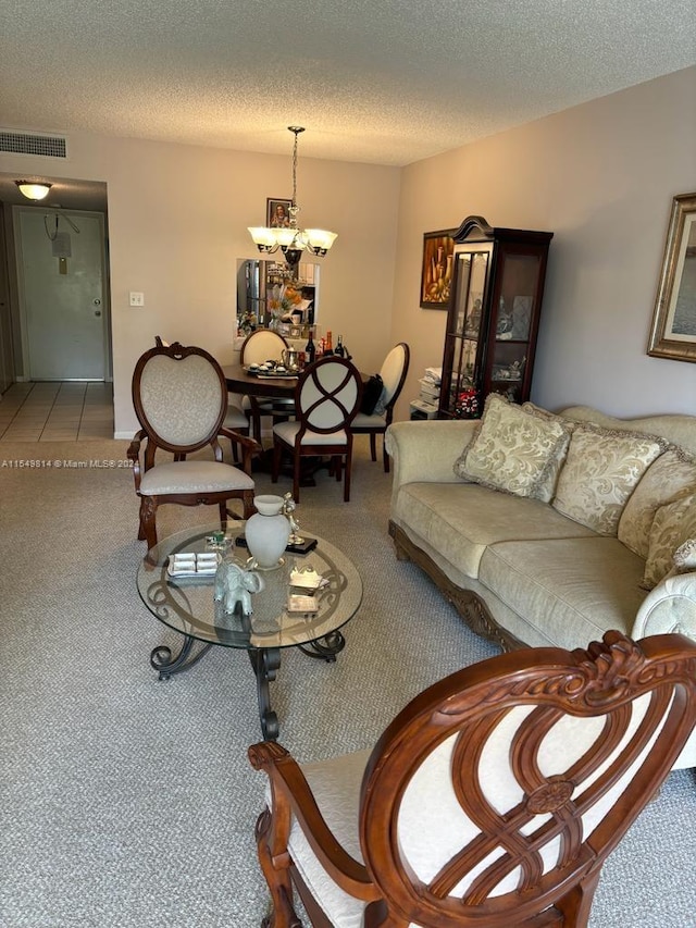 living room with light colored carpet, a notable chandelier, and a textured ceiling