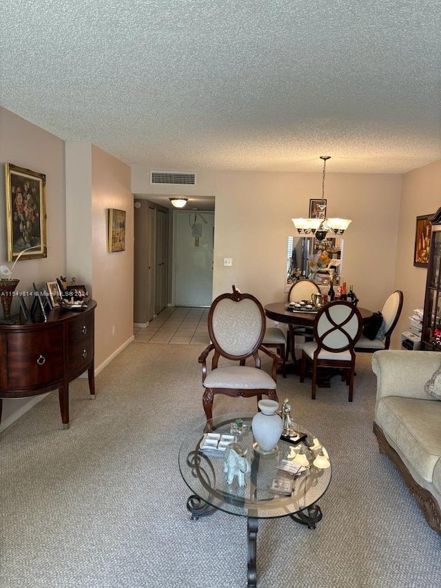 living room with a notable chandelier, a textured ceiling, and light colored carpet