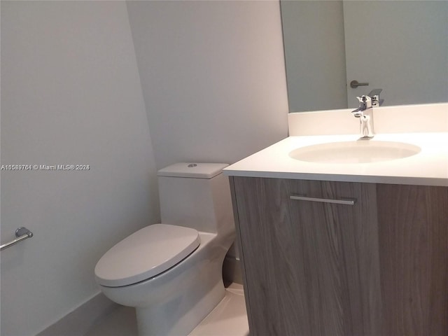 bathroom with toilet and vanity