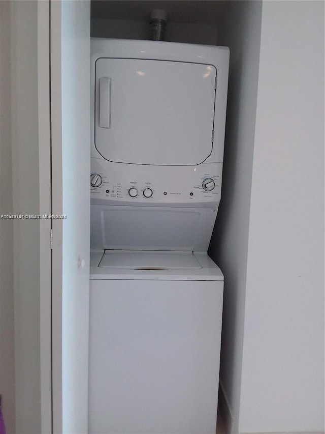 laundry area with stacked washer and clothes dryer