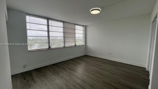 unfurnished bedroom with dark hardwood / wood-style floors