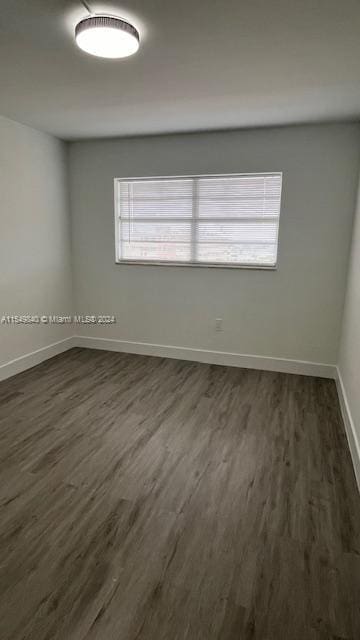 empty room featuring dark wood-type flooring