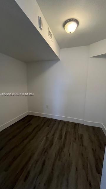 empty room featuring dark wood-type flooring